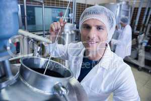 Smiling scientist using brewer in the container