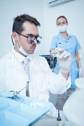 Dentist looking at injection