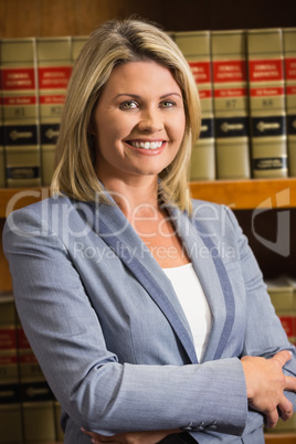 Lawyer smiling at camera in law library