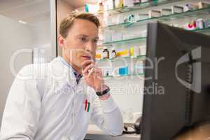 Focused pharmacist using the computer