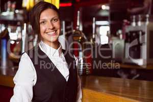 Happy barmaid smiling at camera