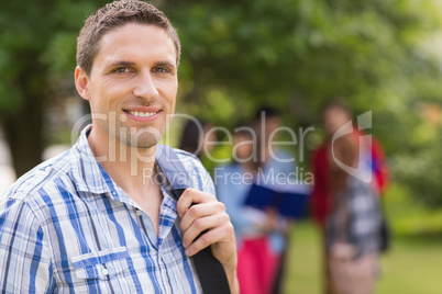 Happy student smiling at camera outside on campus