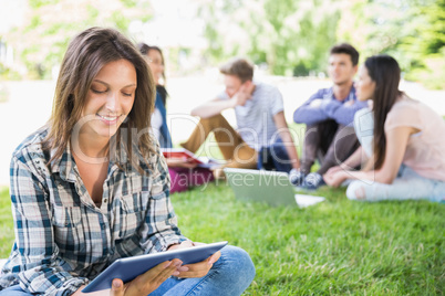 Happy students sitting outside on campus