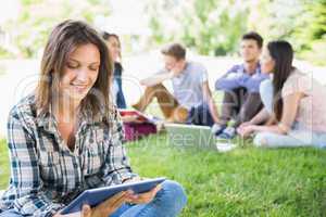 Happy students sitting outside on campus