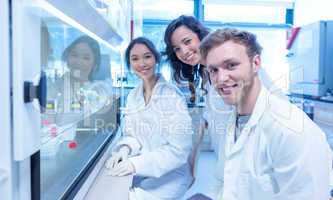 Science students using pipette in the lab