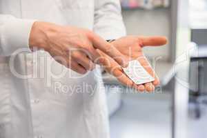 Pharmacist holding medicine blister pack