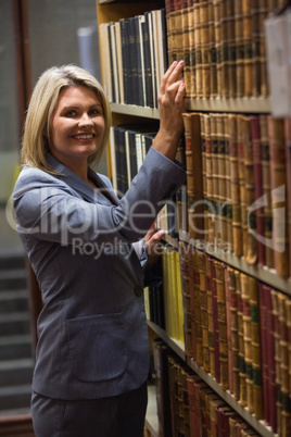 Lawyer picking book in the law library