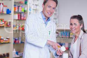 Smiling pharmacist explaining the pills to patient