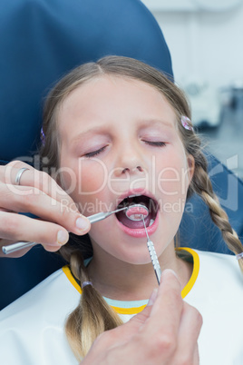 Close up of girl having her teeth examined Close up of girl having her teeth examined