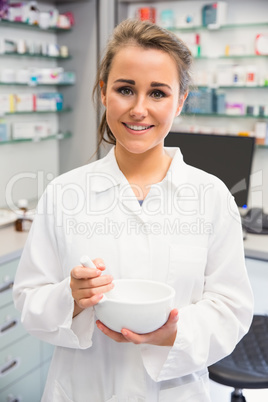 Junior pharmacist mixing a medicine