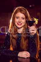 Pretty redhead drinking a cocktail