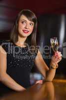 Pretty brunette drinking glass of champagne