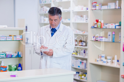 Focused pharmacist writing down notes