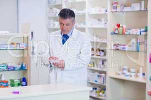 Focused pharmacist writing down notes