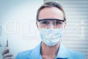Female dentist in surgical mask holding injection