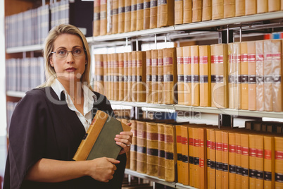 Serious lawyer holding a book