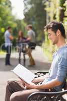 Handsome student studying outside on campus