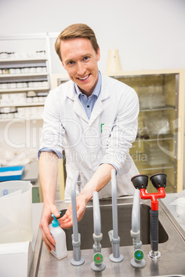 Handsome pharmacist washing his hands