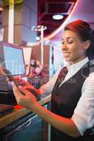 Pretty barmaid using touchscreen till