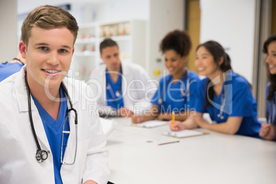 Medical student smiling at the camera during class