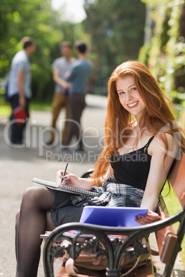Pretty student studying outside on campus