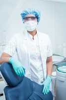 Dentist wearing surgical mask and safety glasses