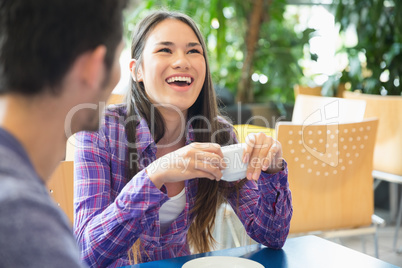 Young students having coffee together