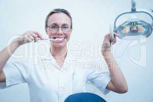Portrait of dentist brushing teeth