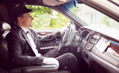 Limousine driver driving and smiling