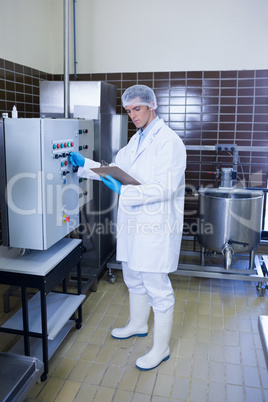 Focused biologist with safety gloves holding clipboard