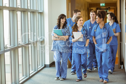 Medical students walking through corridor