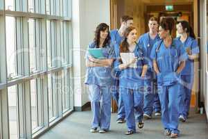 Medical students walking through corridor