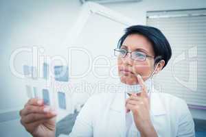 Female dentist looking at x-ray