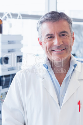 Portrait of a smiling scientist wearing lab coat