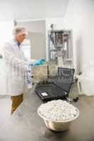 Pharmacist using heavy machinery to make medicine