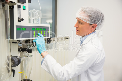 Pharmacist using machinery to make medicine