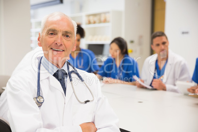 Medical professor smiling at the camera during class