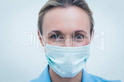 Female dentist wearing surgical mask