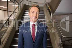 Happy businessman looking at camera