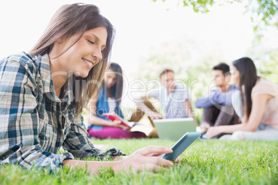 Happy students sitting outside on campus Happy students sitting outside on campus