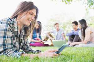 Happy students sitting outside on campus