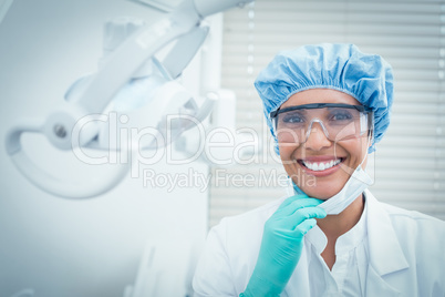 Female dentist wearing surgical cap and safety glasses