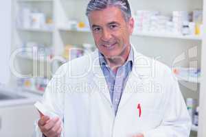 Portrait of a smiling pharmacist wearing lab coat