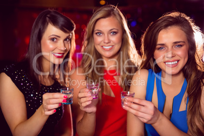 Pretty friends drinking shots together