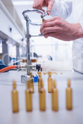 Close up of a biochemist sealing a vial