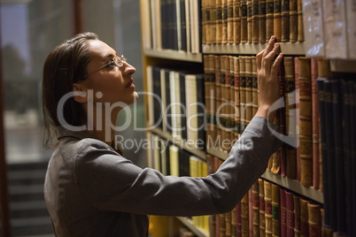 Lawyer picking book in the law library