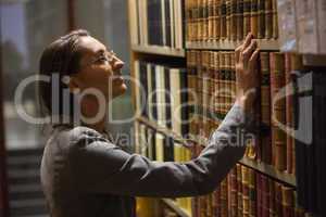 Lawyer picking book in the law library