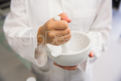 Junior pharmacist mixing a medicine Junior pharmacist mixing a medicine