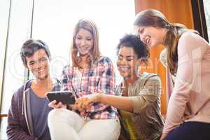 Happy student holding smartphone showing screen