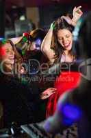 Happy friends dancing by the dj booth